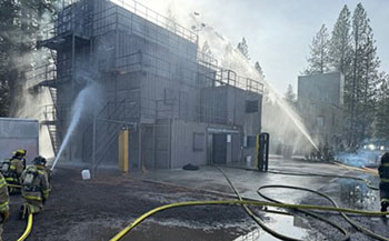 Firefighters fighting fire in fire tower.