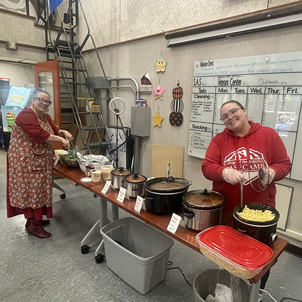 Emkay and Maggie serving meal